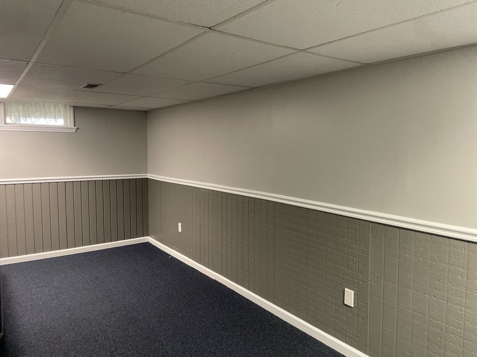 Finished basement with two-tone walls