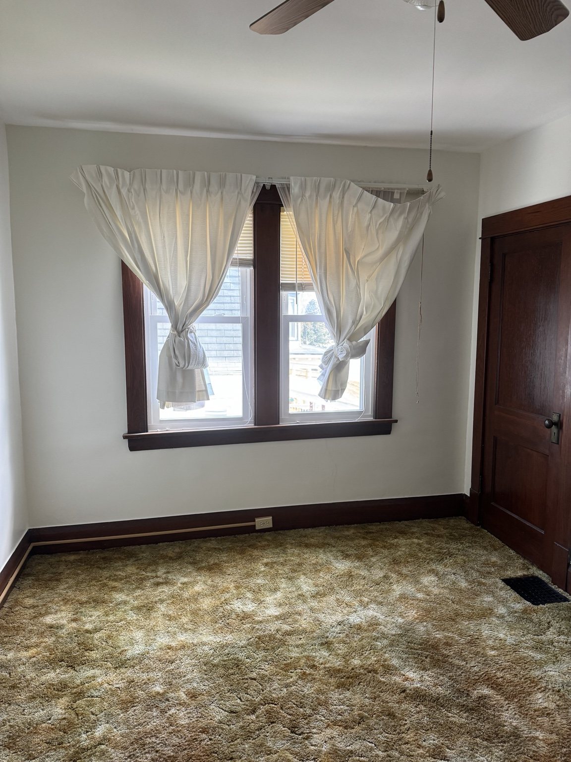 Freshly painted bedroom with dark wood trim